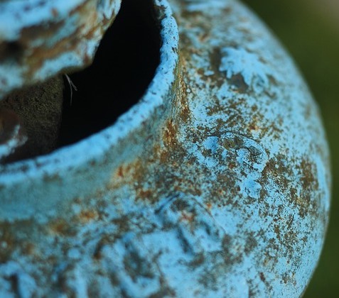 Example of a patina that has formed on a copper vase.